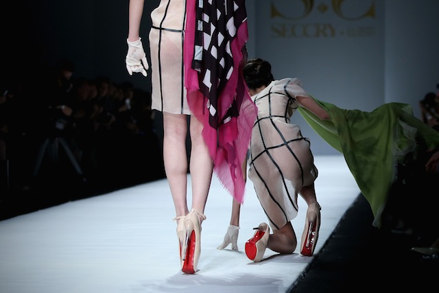 A model showcases designs on the catwalk during the XXXX show on the first day of Mercedes-Benz China Fashion Week Autumn/Winter 2014/2015 at the on March 30, 2014 in Beijing, China.